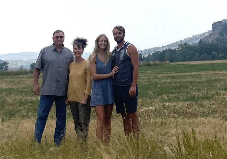 Photo of Copper Rescue team standing in grass in front of the mountains. 