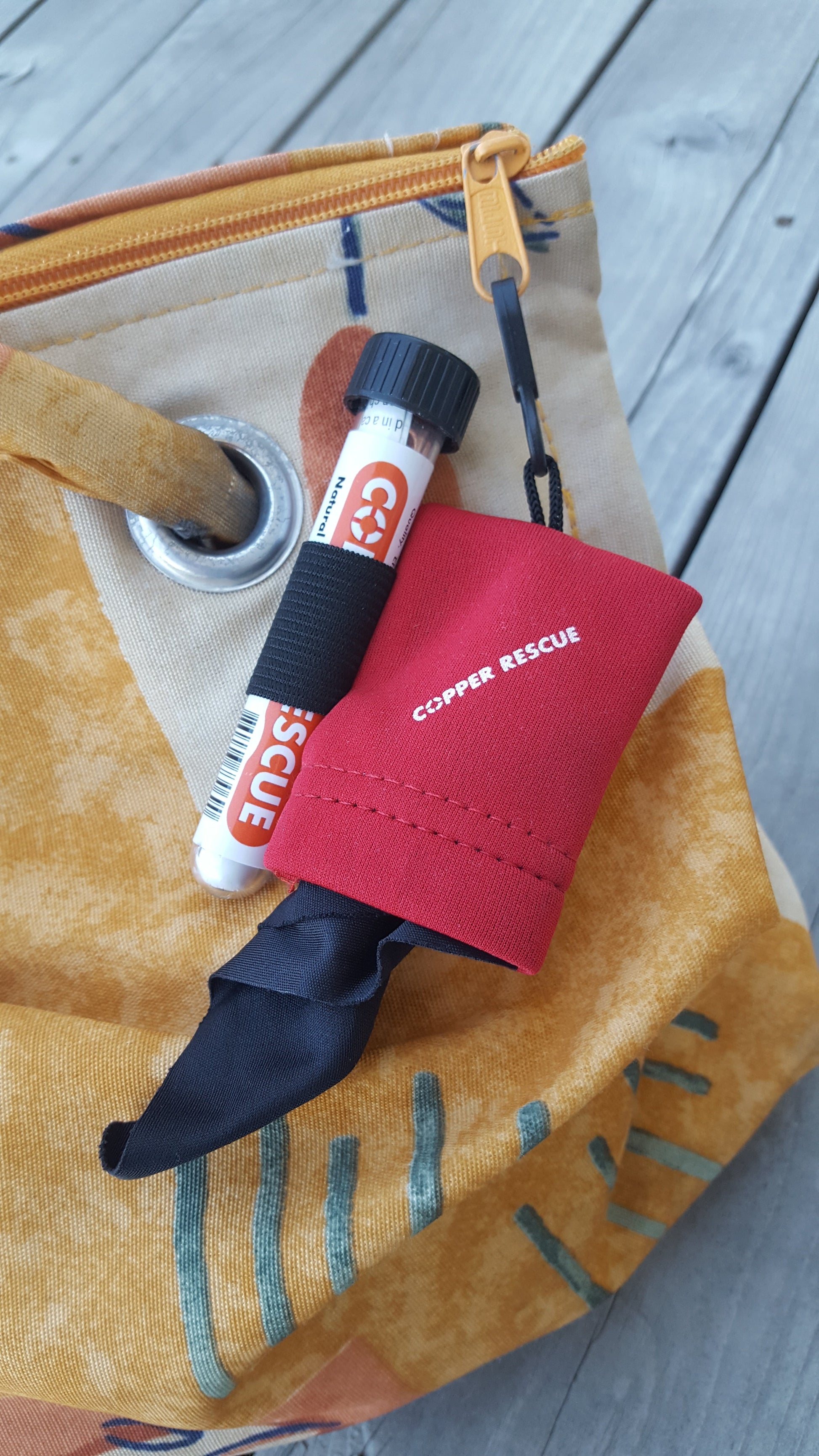 Photo of the Copper Rescue germ wand and clip and clean attached to a bag for travel. 